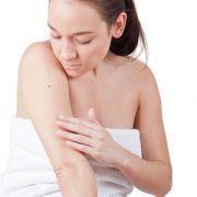 woman checking skin for melanoma